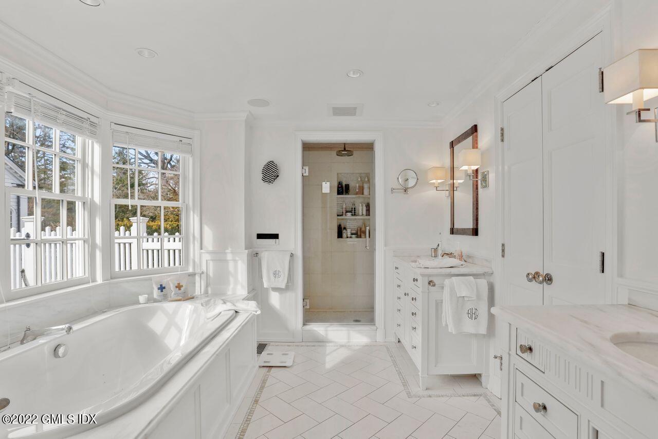 415 Round Hill Road Greenwich, CT 06831 - Photo 19 of 36 a spacious bathroom with a tub sink and mirror