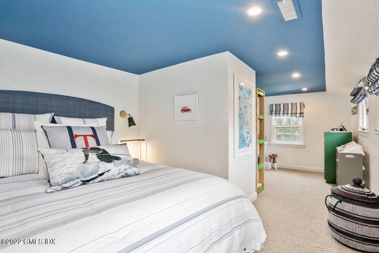 415 Round Hill Road Greenwich, CT 06831 - Photo 21 of 36 a bedroom with a bed and a couch