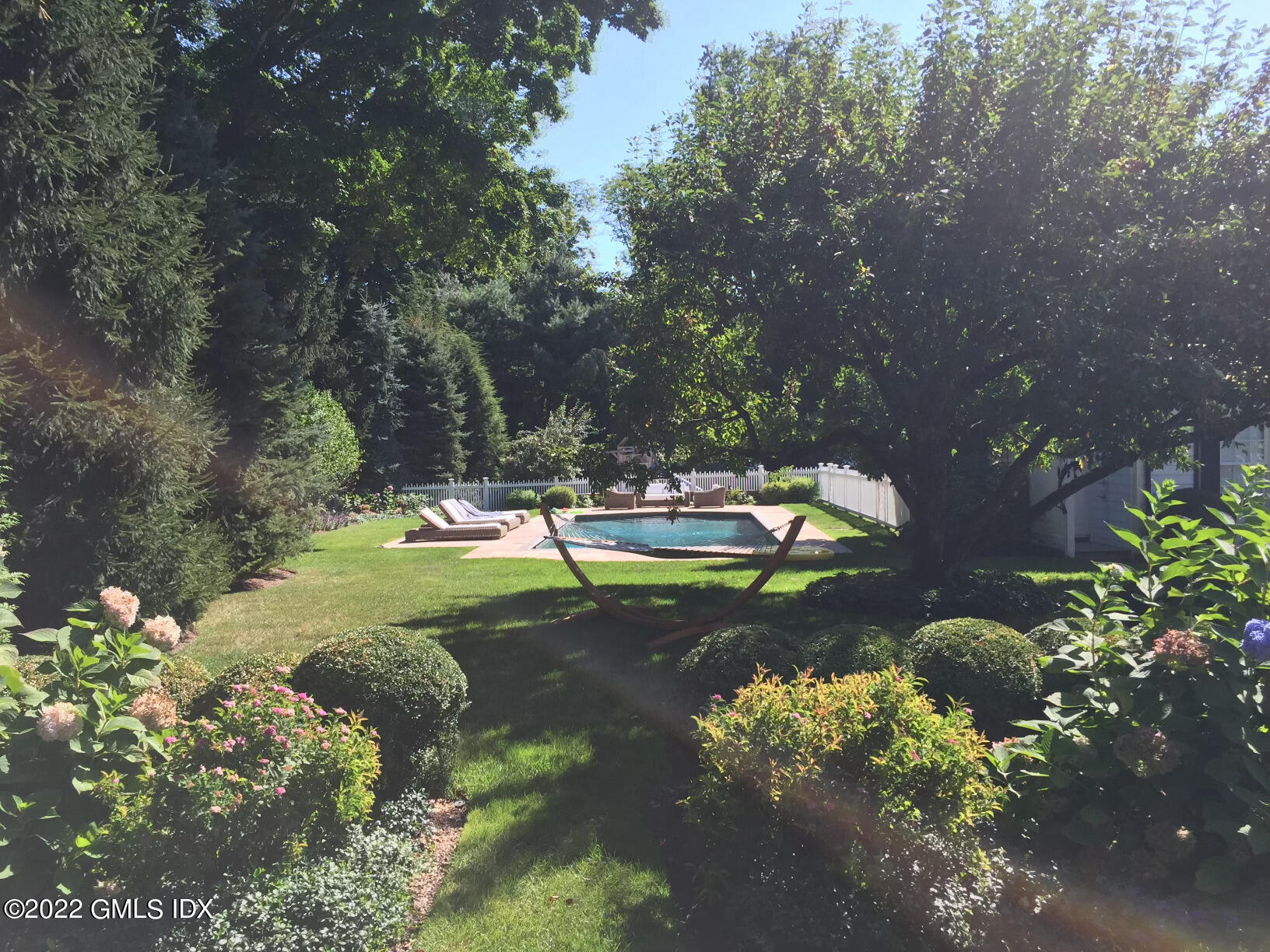 415 Round Hill Road Greenwich, CT 06831 - Photo 29 of 36 a view of a garden with fire pit