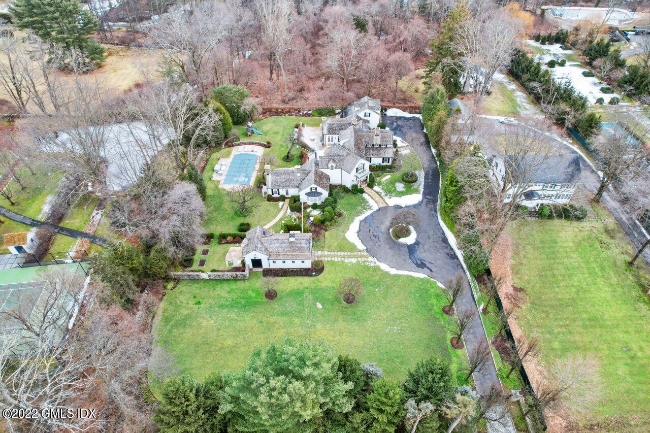 415 Round Hill Road Greenwich, CT 06831 - Photo 31 of 36 an aerial view of a house with a yard and lake view