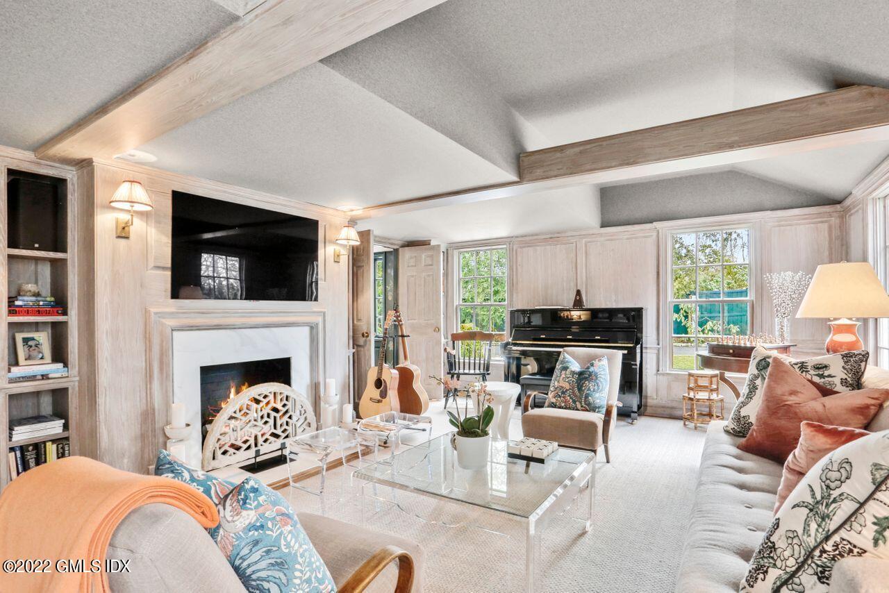 415 Round Hill Road Greenwich, CT 06831 - Photo 9 of 36 a living room with furniture fireplace and a flat screen tv