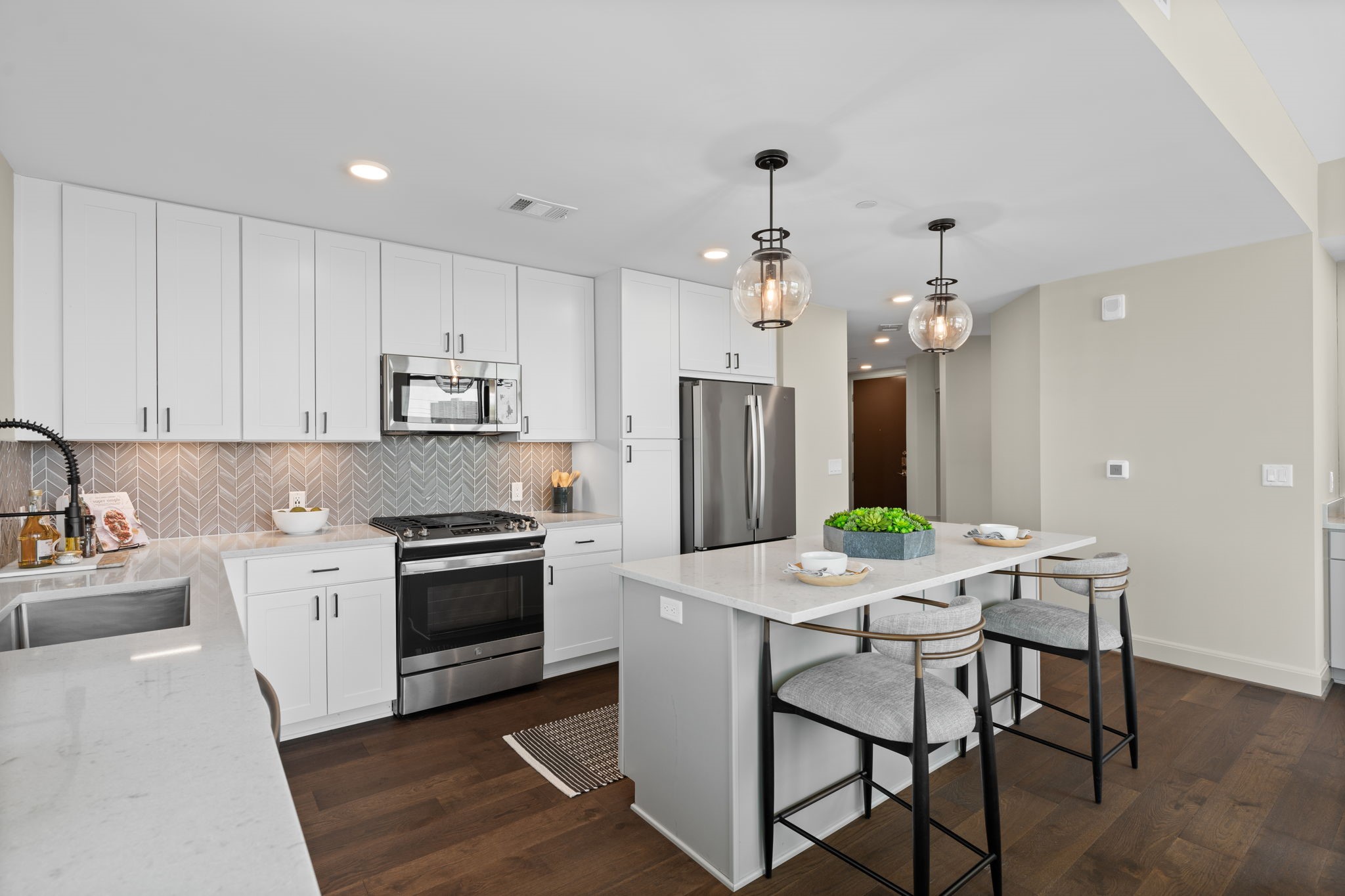 2511 Willowick Road, Unit 317 Houston, TX 77027 - Photo 7 of 44 a kitchen that has a table chairs and stainless steel appliances