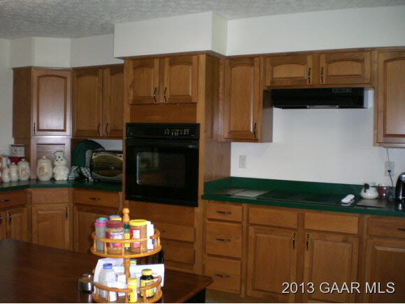 1115 Middlebrook Road Staunton, VA 24401 - Photo 8 of 12 a kitchen with granite countertop cabinets and black appliances