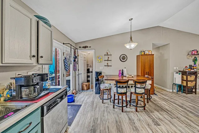 a view of a dining room with furniture and wooden floor