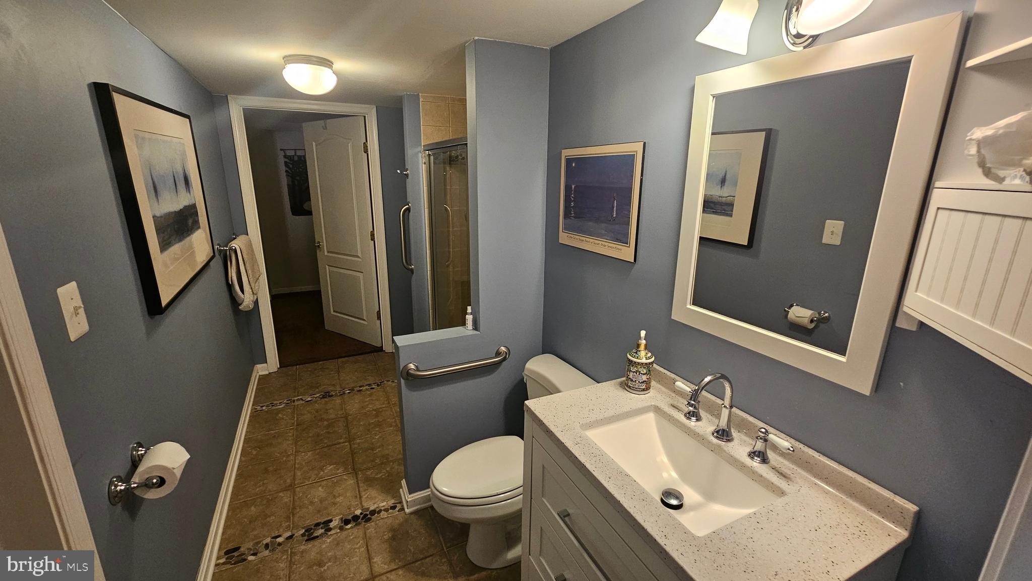 6107 Traceys Overlook Road Tracys Landing, MD 20779 - Photo 44 of 67 a bathroom with a sink toilet and shower a mirror