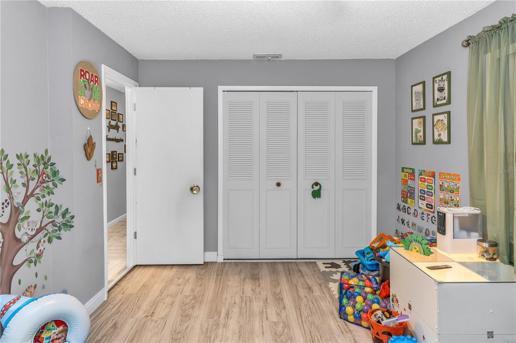 1186 Azora Drive Deltona, FL 32725 - Photo 13 of 24 a view of hallway with toys and wooden floor