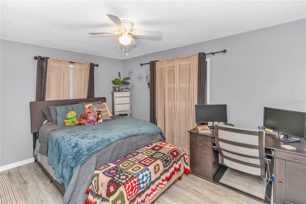 1186 Azora Drive Deltona, FL 32725 - Photo 14 of 24 a bedroom with a bed and a flat screen tv