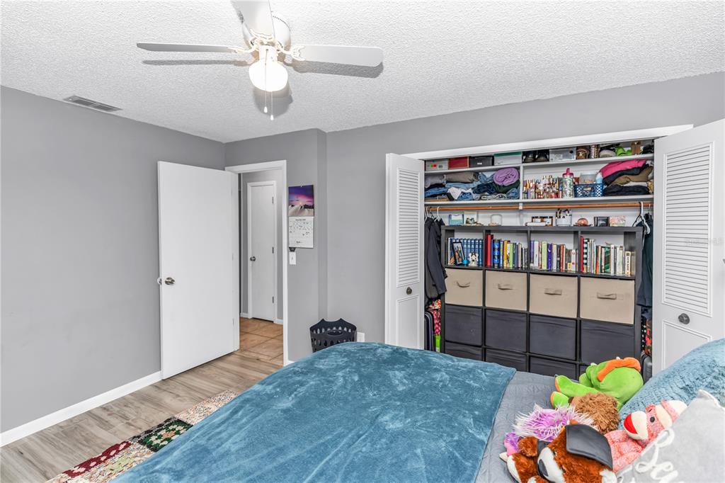 1186 Azora Drive Deltona, FL 32725 - Photo 15 of 24 a bedroom with furniture and a book shelf