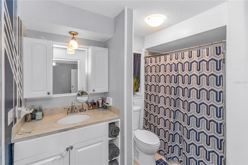 1186 Azora Drive Deltona, FL 32725 - Photo 16 of 24 a bathroom with a granite countertop sink a toilet and a mirror