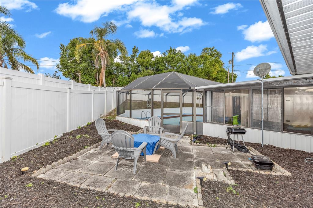 1186 Azora Drive Deltona, FL 32725 - Photo 21 of 24 a view of a patio with a table and chairs