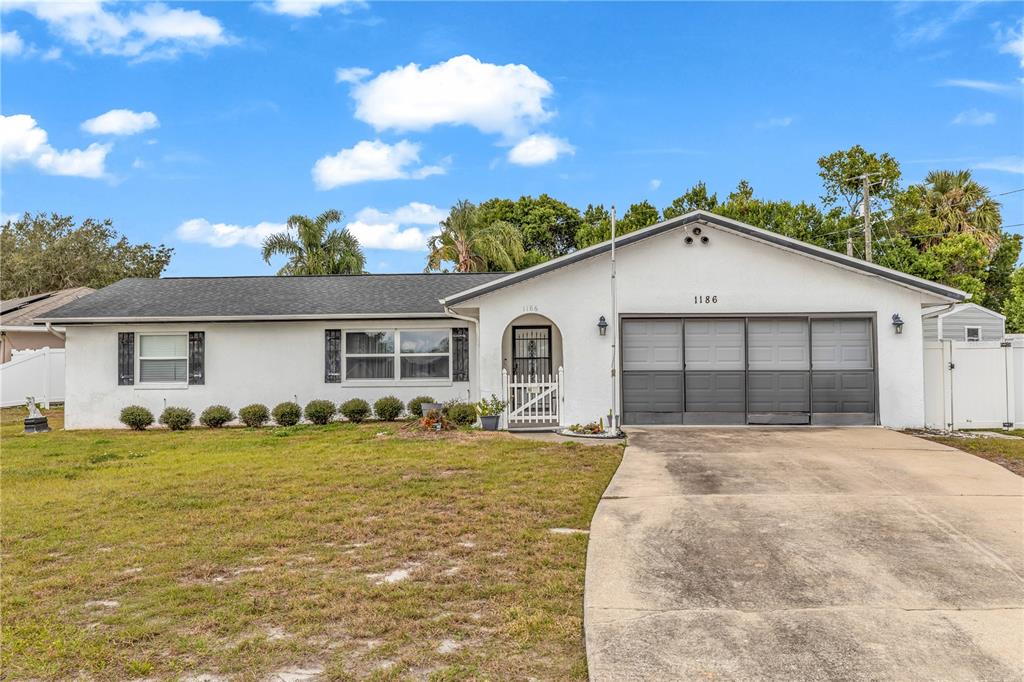 1186 Azora Drive Deltona, FL 32725 - Photo 22 of 24 a view of a house with a yard