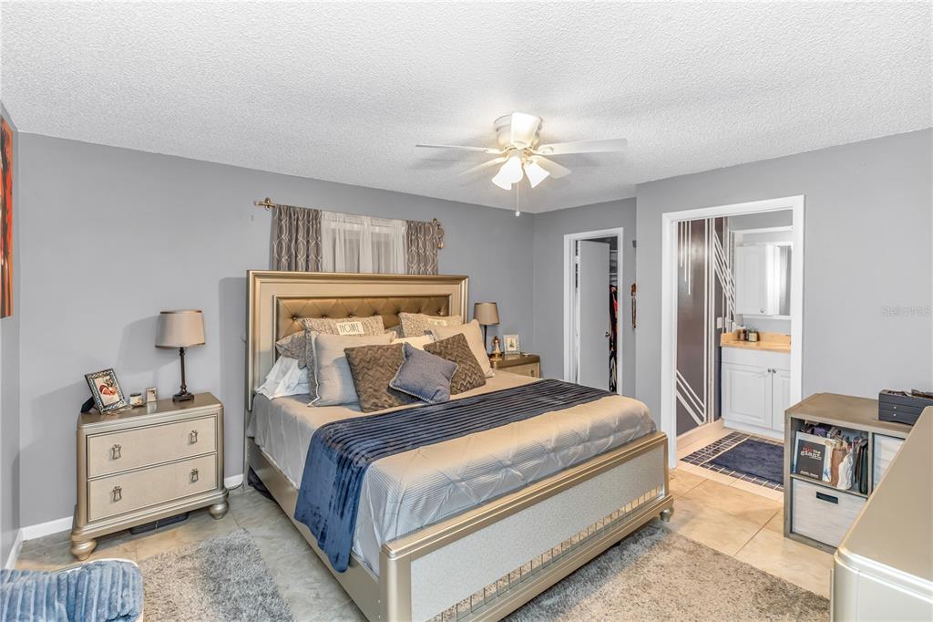 1186 Azora Drive Deltona, FL 32725 - Photo 9 of 24 a bedroom with a bed and a chandelier