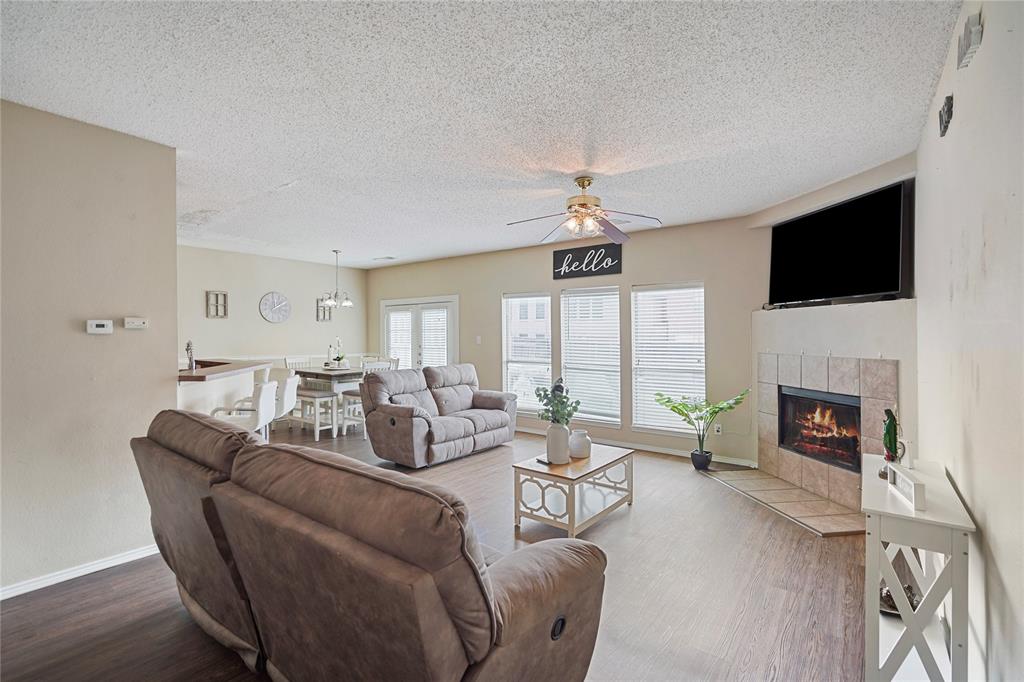 1934 Pin Oak Lane Lancaster, TX 75146 - Photo 12 of 27 a living room with furniture fireplace and a flat screen tv