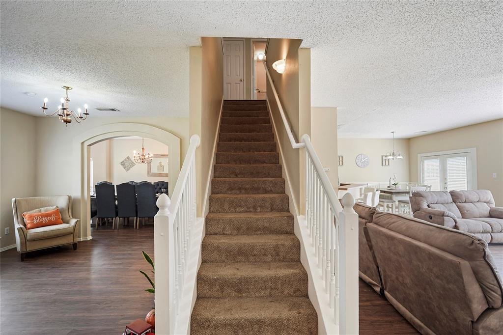 1934 Pin Oak Lane Lancaster, TX 75146 - Photo 15 of 27 a living room with furniture and a chandelier