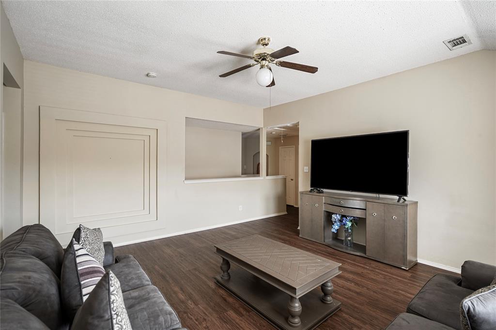 1934 Pin Oak Lane Lancaster, TX 75146 - Photo 17 of 27 a living room with furniture and a flat screen tv