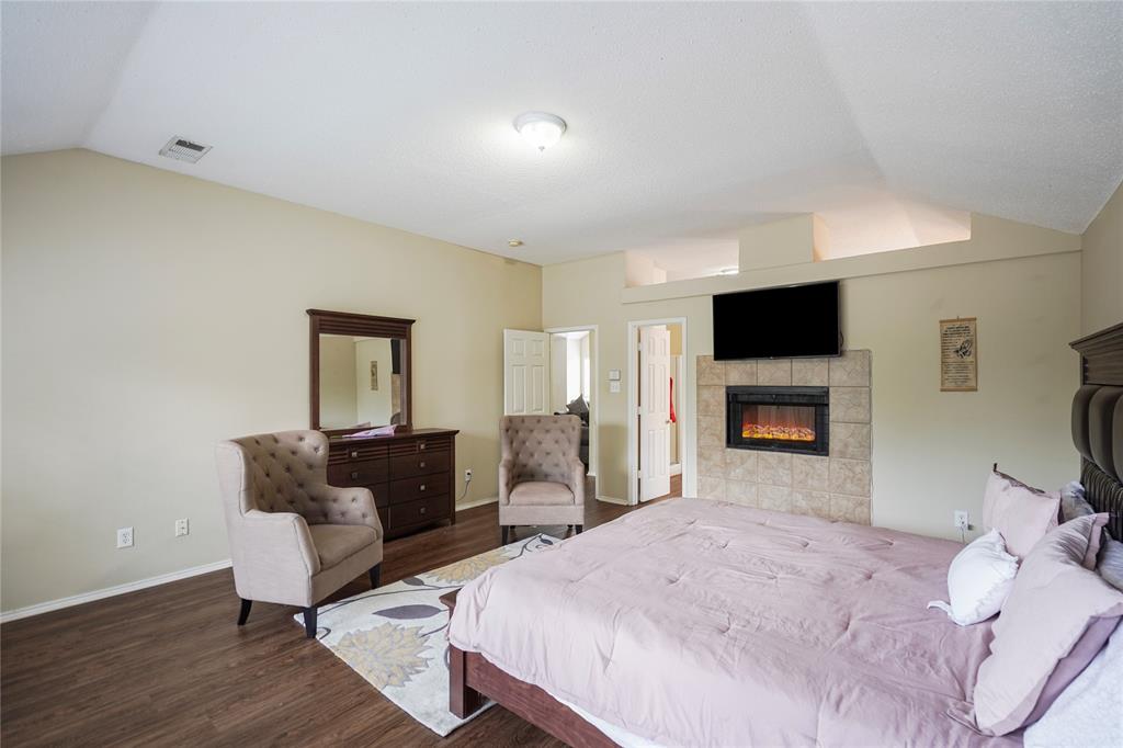 1934 Pin Oak Lane Lancaster, TX 75146 - Photo 19 of 27 a bedroom with a bed and a television