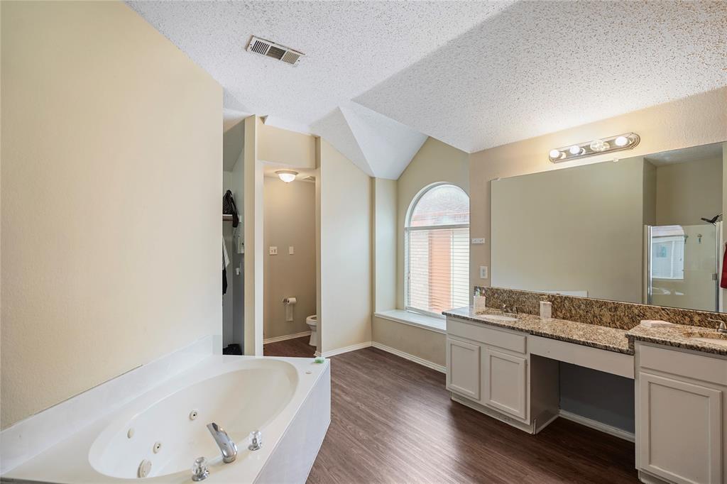 1934 Pin Oak Lane Lancaster, TX 75146 - Photo 20 of 27 a bathroom with a granite countertop tub sink and mirror