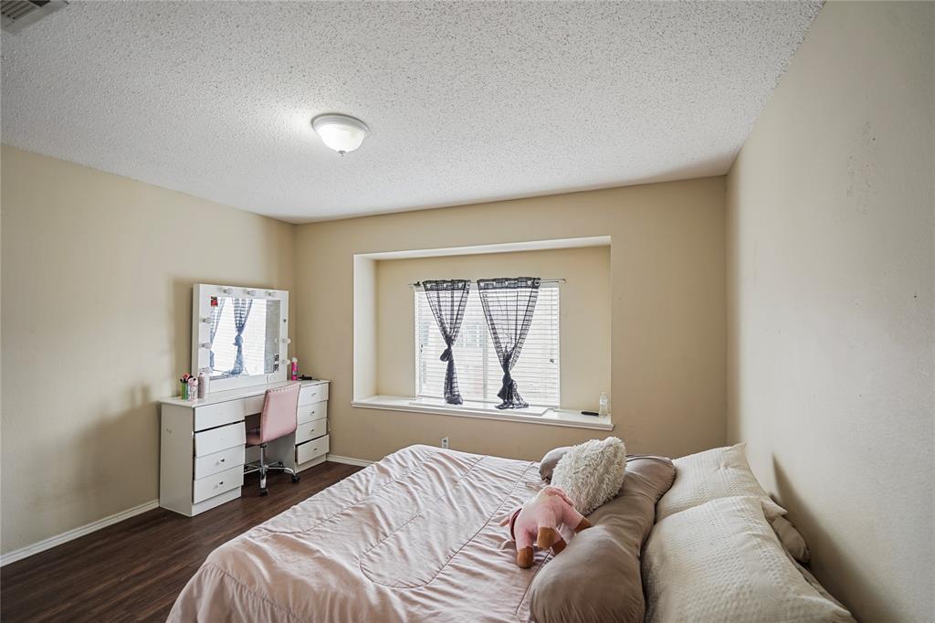 1934 Pin Oak Lane Lancaster, TX 75146 - Photo 23 of 27 a bedroom with a bed and a window