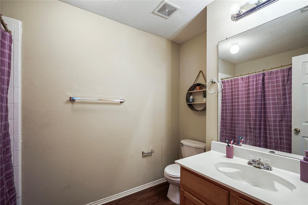 1934 Pin Oak Lane Lancaster, TX 75146 - Photo 24 of 27 a bathroom with a sink a toilet and shower