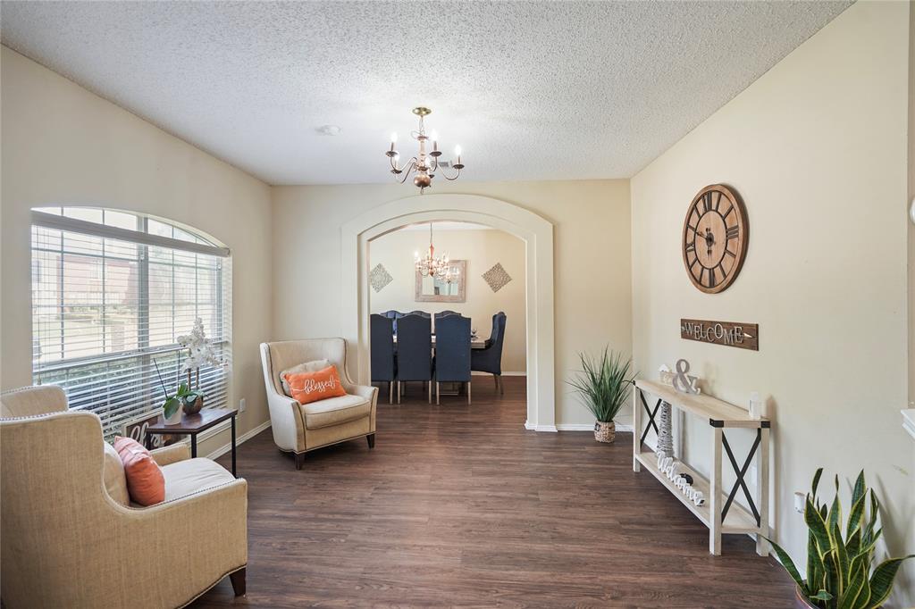 1934 Pin Oak Lane Lancaster, TX 75146 - Photo 4 of 27 a living room with furniture chandelier and a large window