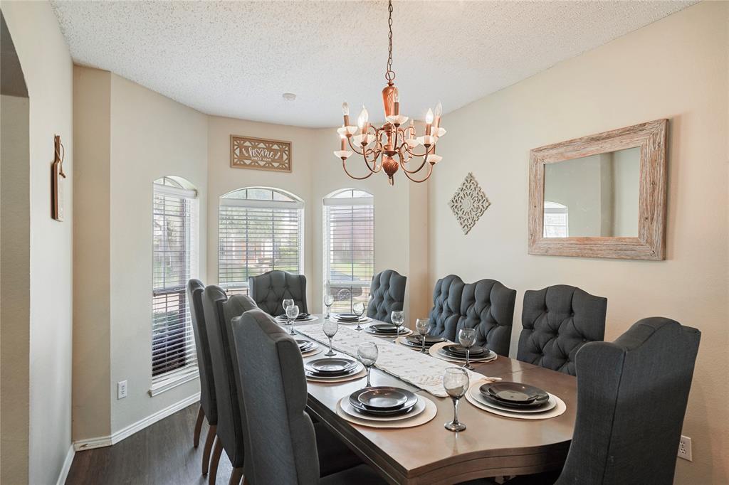 1934 Pin Oak Lane Lancaster, TX 75146 - Photo 6 of 27 a view of a dining room with furniture wooden floor and chandelier