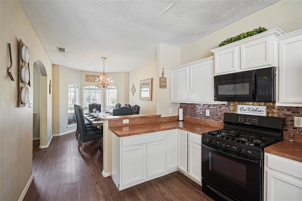 1934 Pin Oak Lane Lancaster, TX 75146 - Photo 7 of 27 a kitchen with a stove and a microwave