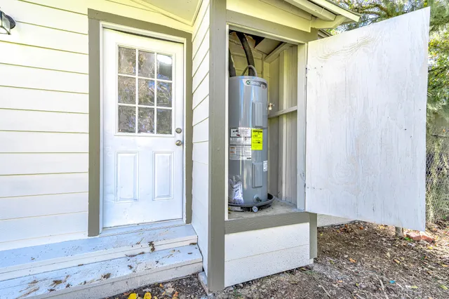 a living room with a bed and a dresser