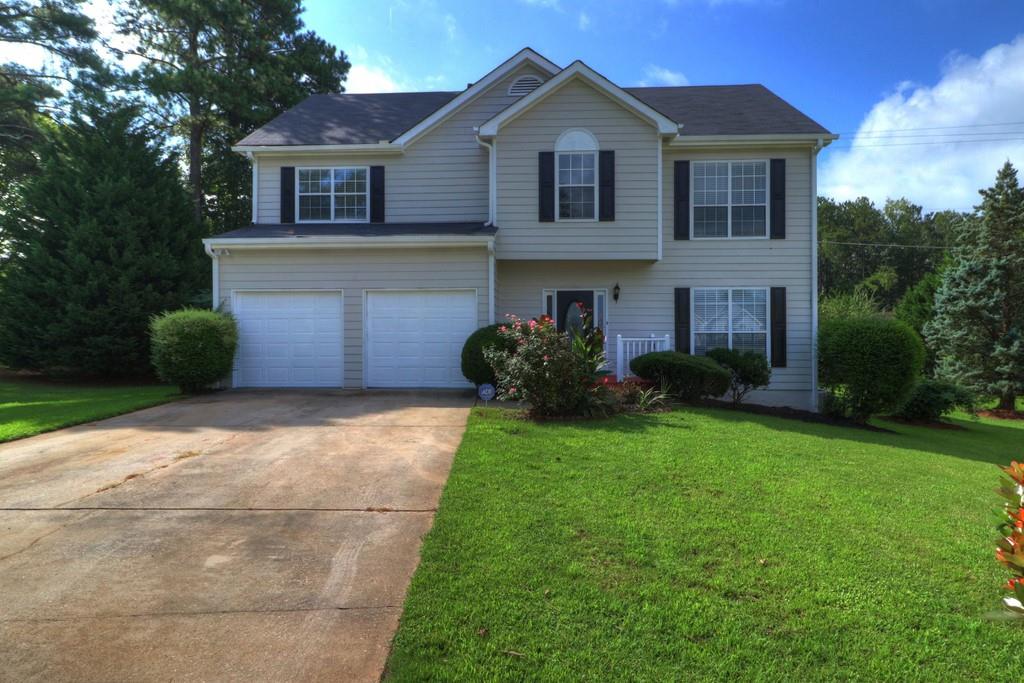 1469 Glynn View Court Hampton, GA 30228 - Photo 1 of 1 a front view of a house with a yard and garage
