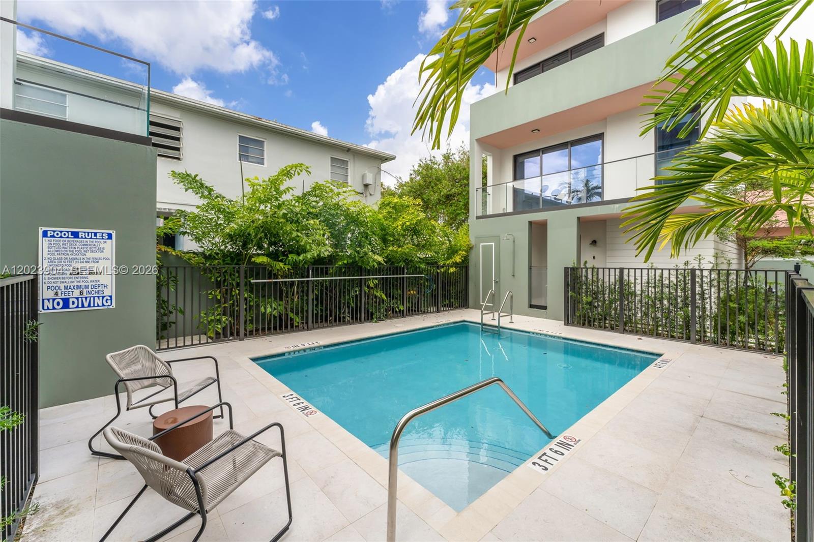 721 Southwest 11th Street, Unit G Miami, FL 33129 - Photo 38 of 40 a view of a swimming pool with a lounge chairs