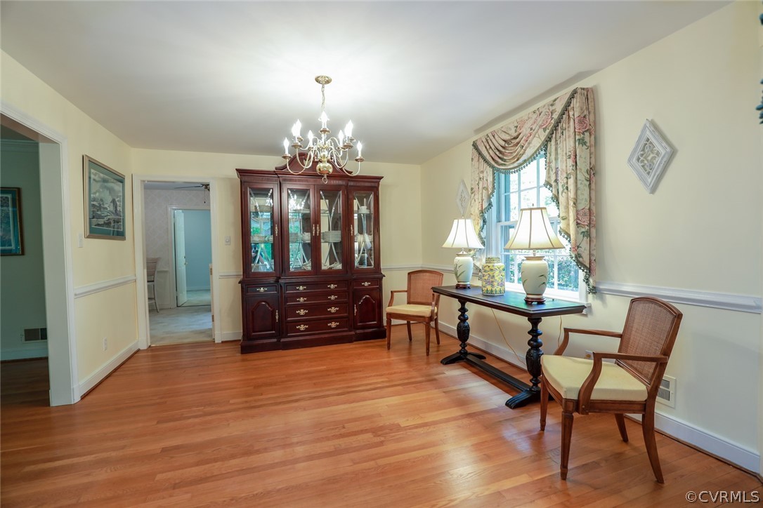 4317 Wakefield Road Richmond, VA 23235 - Photo 7 of 43 a living room with furniture and a chandelier