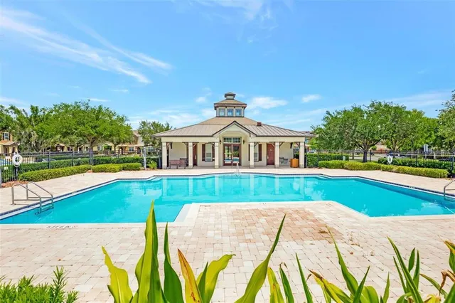 a view of house with swimming pool outdoor seating