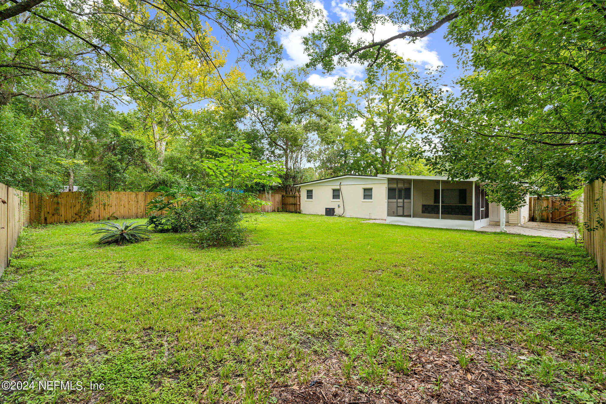 6974 Rollo Road Jacksonville, FL 32205 - Photo 15 of 16 a front view of house with yard and green space