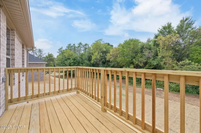 a balcony with wooden floor and fence