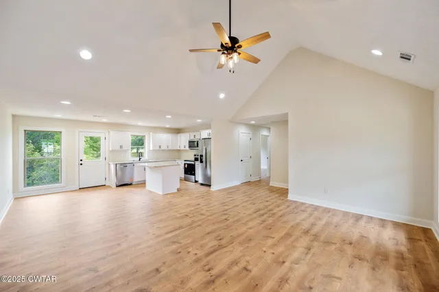 a view of a kitchen with a stove cabinets and a floor to ceiling window