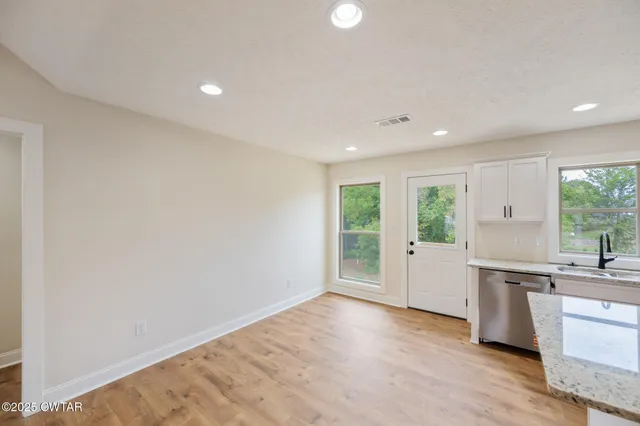 a view of a kitchen with a sink and a window