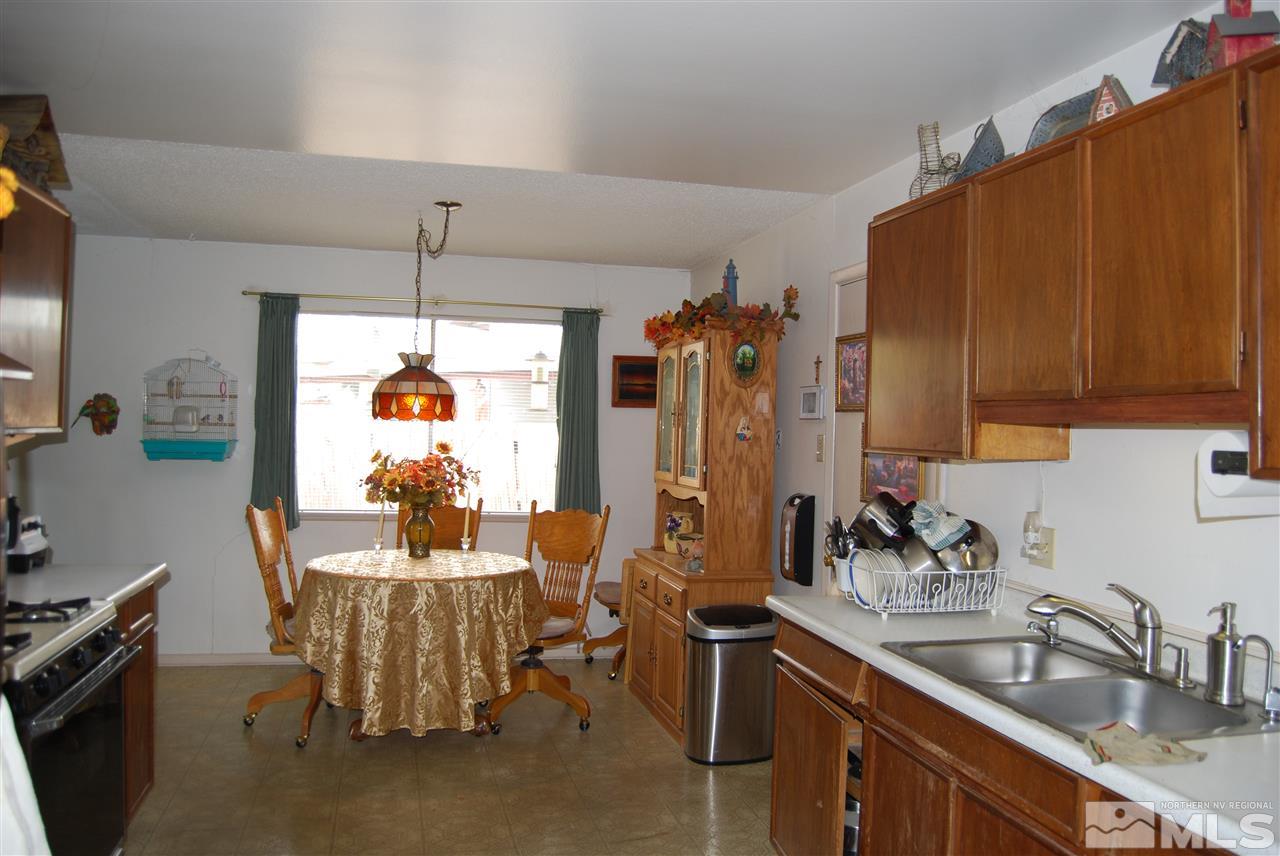 3090 Accacia Way Reno, NV 89503 - Photo 3 of 5 a kitchen with furniture a sink a window and stainless steel appliances
