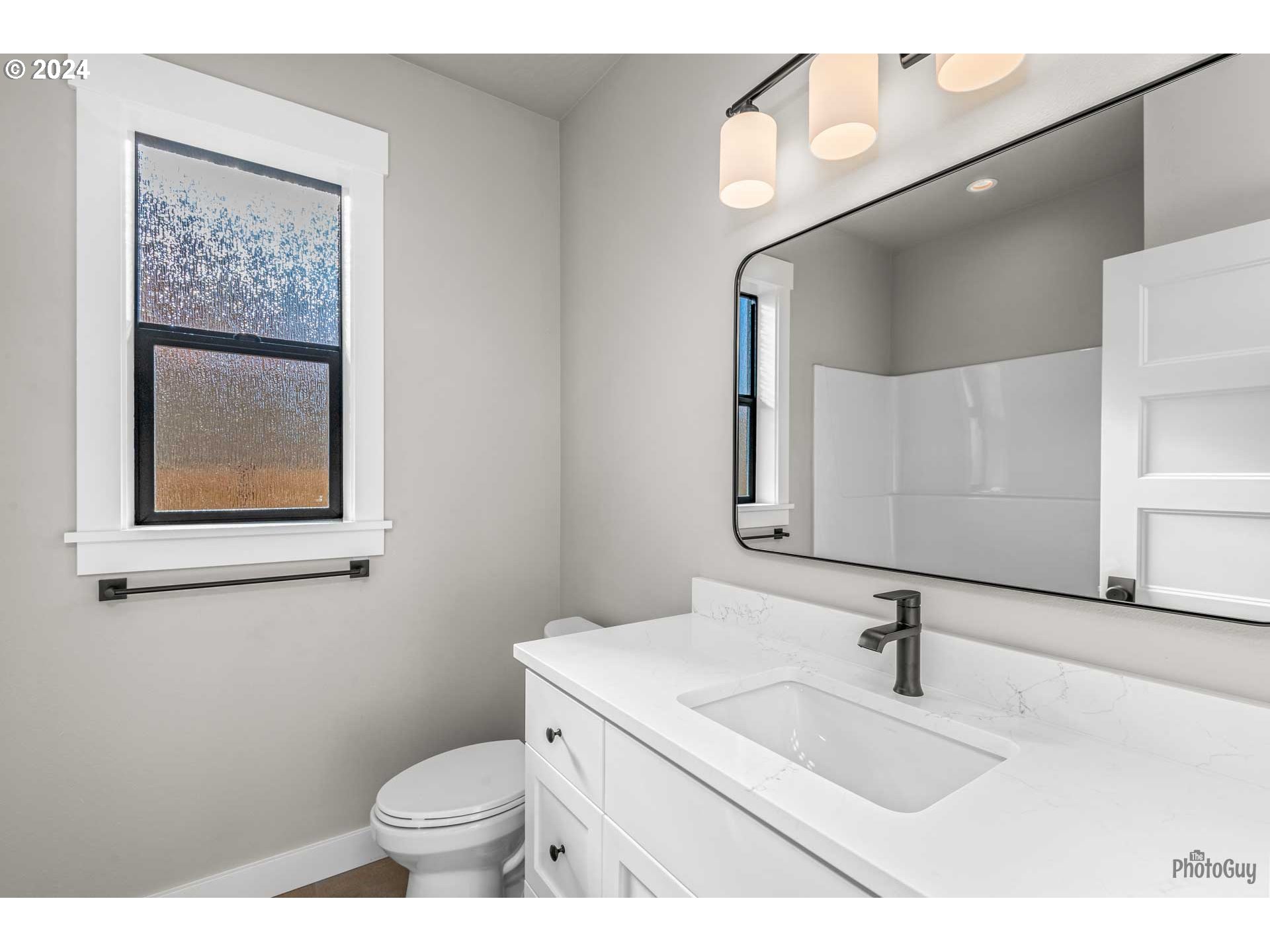 32748 Coburg Road Eugene, OR 97408 - Photo 20 of 35 a bathroom with a toilet sink and mirror