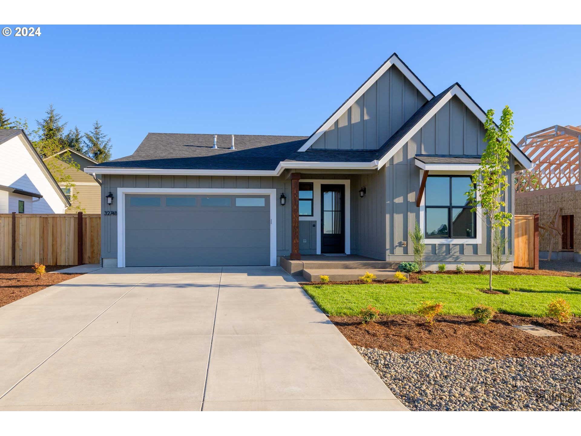32748 Coburg Road Eugene, OR 97408 - Photo 2 of 35 a front view of a house with a yard outdoor seating and garage