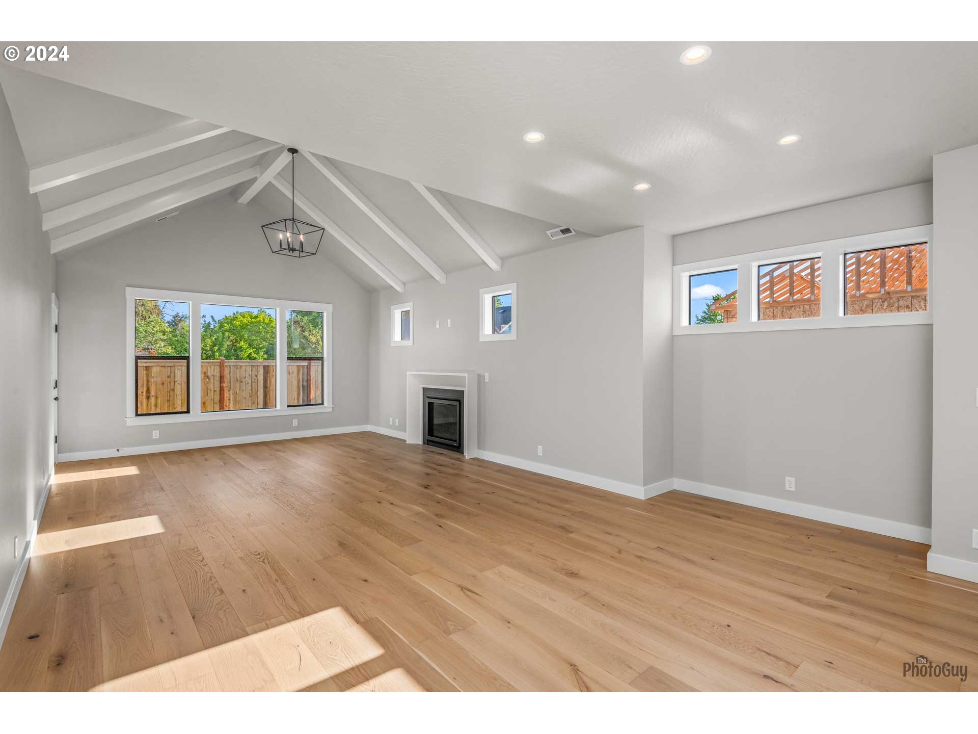 32748 Coburg Road Eugene, OR 97408 - Photo 6 of 35 a view of an empty room with wooden floor and a window