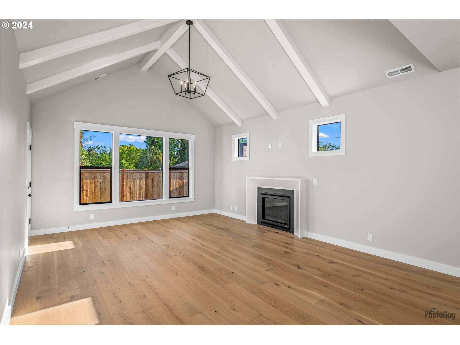 32748 Coburg Road Eugene, OR 97408 - Photo 8 of 35 a view of empty room with wooden floor and fireplace
