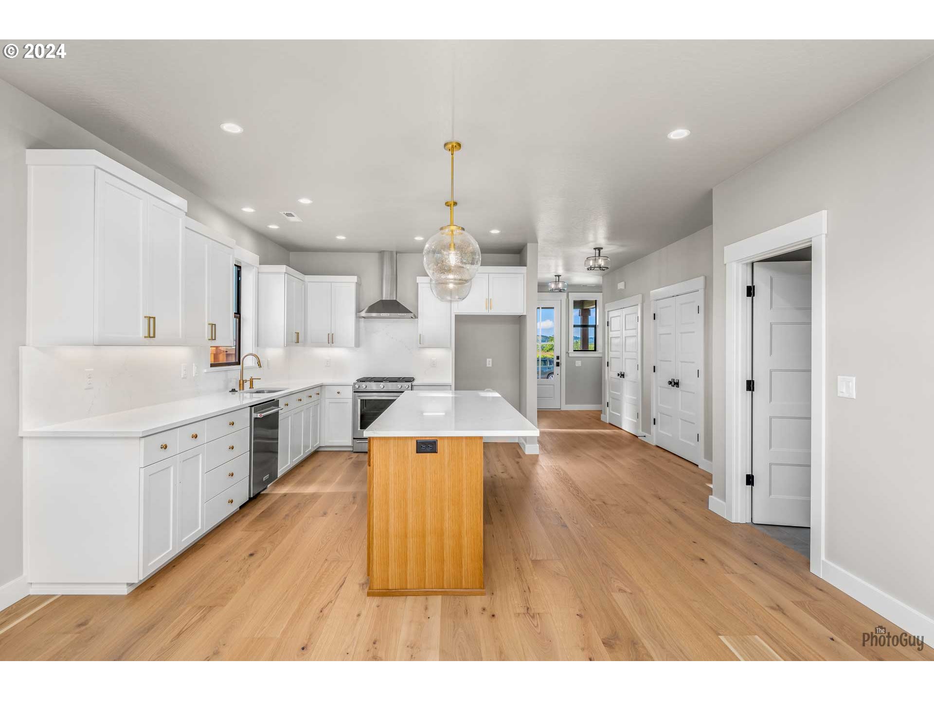32748 Coburg Road Eugene, OR 97408 - Photo 10 of 35 a large kitchen with cabinets a sink and a refrigerator