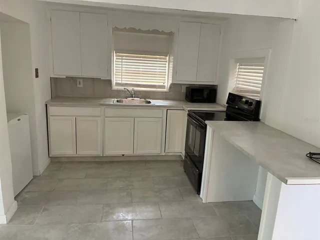 a kitchen with a sink and a stove top oven