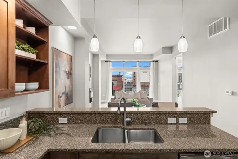 a bathroom with a granite countertop sink and a mirror