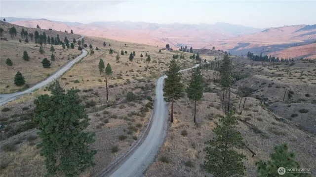 an aerial view of mountain with residential house and mountain view