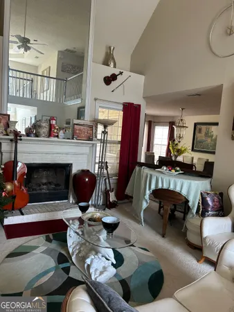 a dining room with furniture a rug and a chandelier