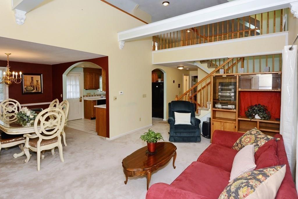 a living room with furniture and a mirror