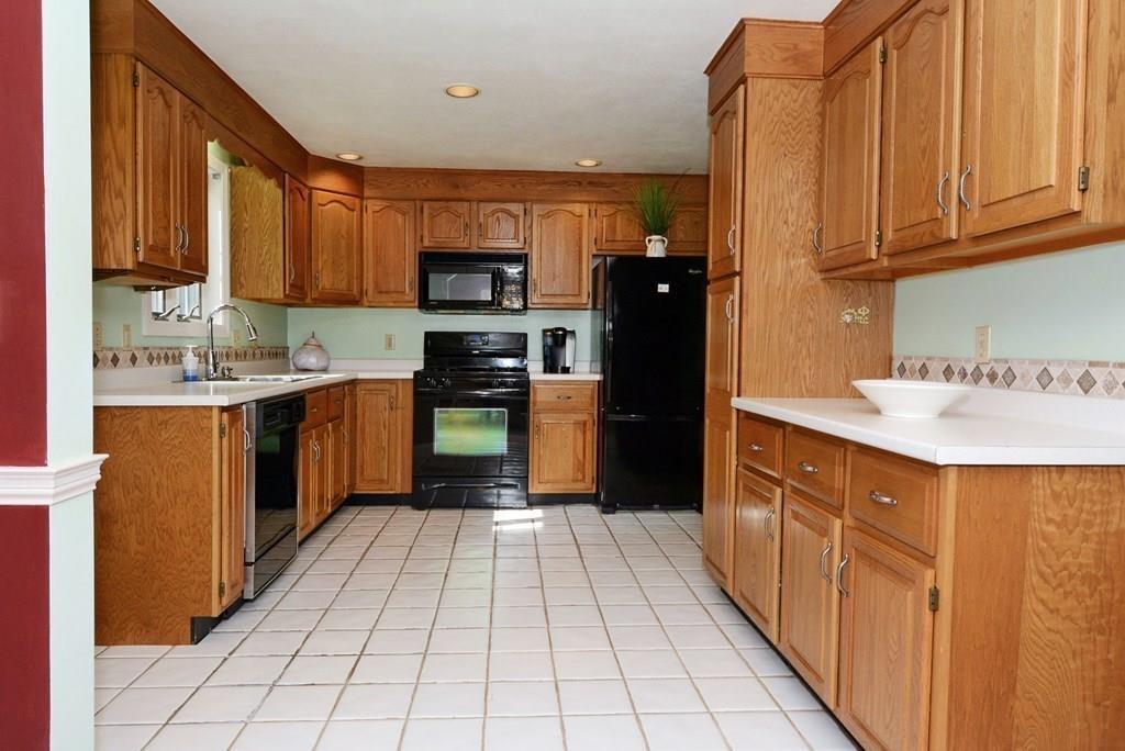 24 1st Street Amesbury, MA 01913 - Photo 11 of 42 a kitchen with stainless steel appliances a sink cabinets and a window
