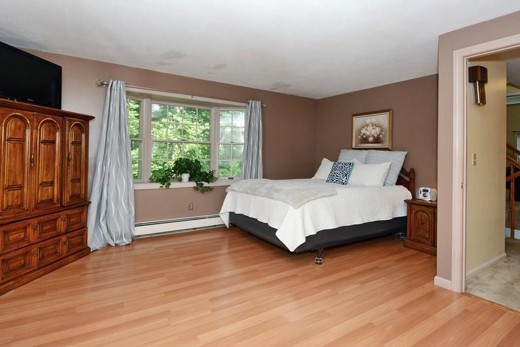 24 1st Street Amesbury, MA 01913 - Photo 14 of 42 a bedroom with a bed wooden floor and window