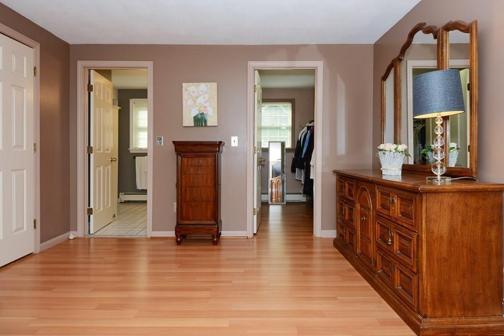 24 1st Street Amesbury, MA 01913 - Photo 15 of 42 a hallway with wooden floor and staircase