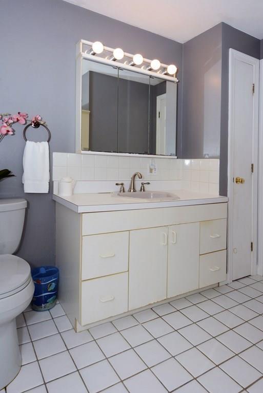 24 1st Street Amesbury, MA 01913 - Photo 18 of 42 a bathroom with a sink toilet and mirror